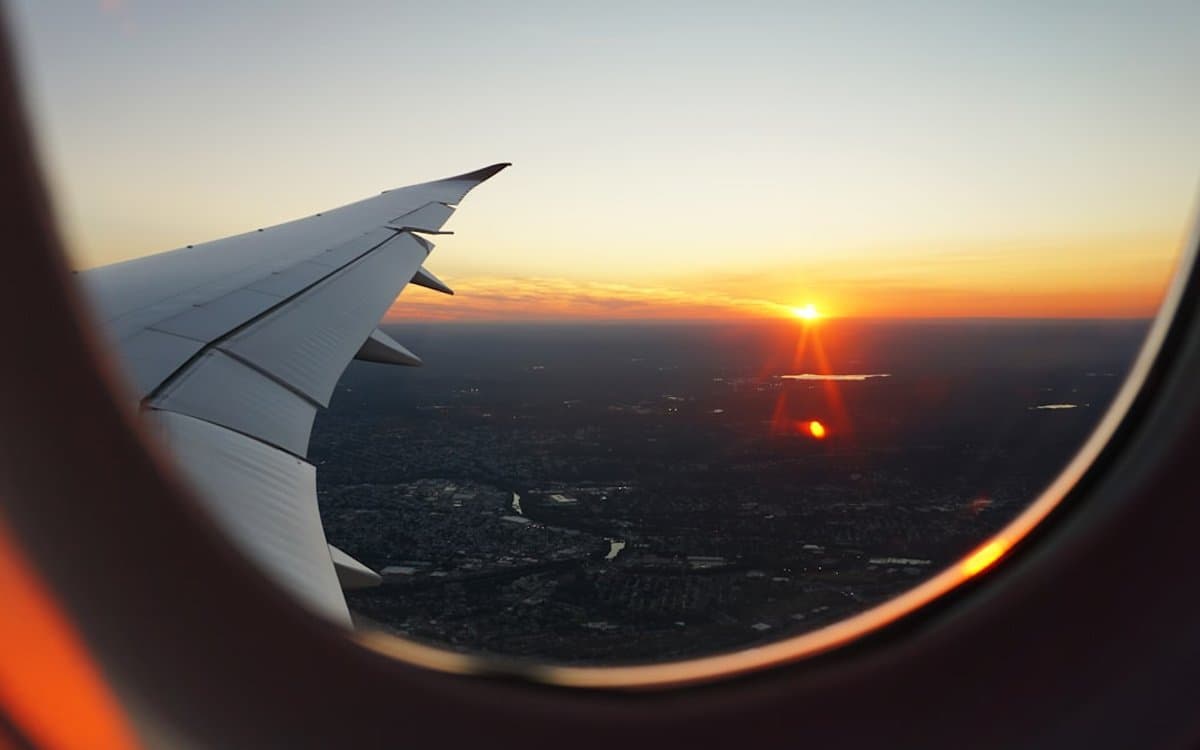 View from an airplane window above the clouds